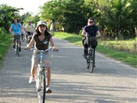 Foreigners cycle in the Mekong Delta on a Terravede weekend cruise tour.